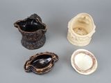 four different types of ceramic vases on a gray surface