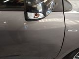 a close up of a car door handle with a sticker on it