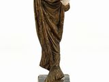 statue of a woman holding a staff on a marble base