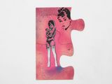 a pink puzzle piece with a picture of a woman and a man