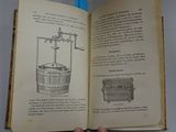 someone is holding a book open with a drawing of a water well