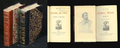 several old books are lined up on a black surface