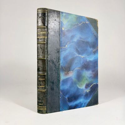 an old book sitting on top of a white table next to a white wall
