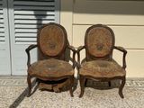 two chairs sitting next to each other on the sidewalk