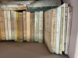 a lot of books that are stacked on top of each other
