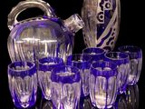 a lot of glasses and a pitcher sitting on a table