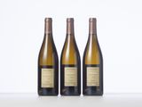 three bottles of wine sitting on top of a table next to each other