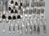a lot of spoons and forks on the table