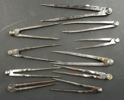 six pairs of surgical instruments sitting on top of a table