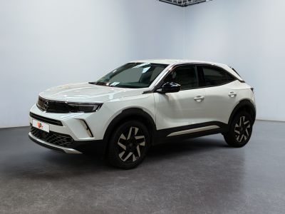 a white suv parked in a room with a ceiling fan