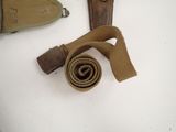 a picture of a belt and a knife on a table