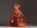 a very large red gummy bear sitting on a white surface