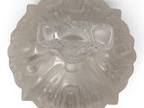 a glass plate with a bird on it on a white surface