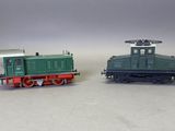 deux petits trains assis côte à côte sur une surface blanche