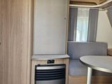 an image of a kitchen and living room in a camper