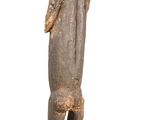 wooden statue of a man with a hat and a cane