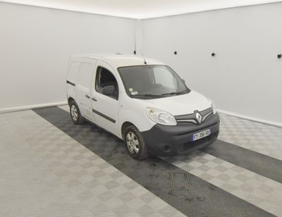 une camionnette blanche garée dans une pièce dont le sol est en damier noir et blanc