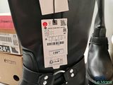 a pair of black boots with a price tag on them