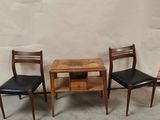 three chairs and a table in the corner of a room