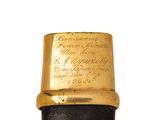 an image of a black and gold cane with writing on it