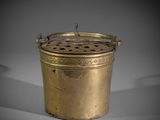 an old brass pot with a lid and a handle