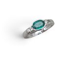a close up of a ring on a white surface with a green stone