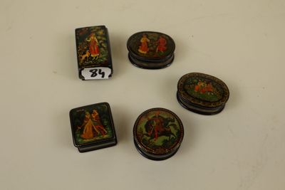 four small decorative boxes are sitting on a white surface