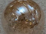 a glass ball sitting on the floor on the floor