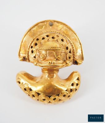 a close up of a gold object on a white surface