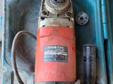 a drill in a case with a wren in it