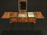 an antique wooden dressing table with a mirror on top of it