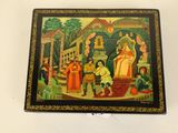 painting of a religious scene on a wooden box on a white surface