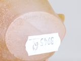 a person holding a plastic piggy with a price tag on it