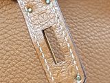 a close up of a purse with a metal handle