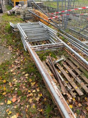 a fence that has been knocked over by a pile of wood