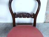 a chair with a pink seat and a wooden frame