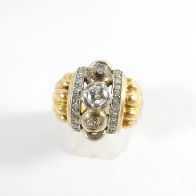 a close up of a gold and diamond ring on a white surface