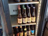 a refrigerator filled with bottles of beer in a room