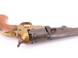 an old revolver with a wooden handle on a white background