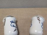two salt and pepper shakers sitting on a table