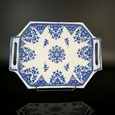 a blue and white platter with a floral design on it