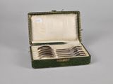 silverware in a green case with a handle and four spoons
