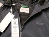 a close up of a black jacket with a tag on it