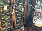 a metal stand with a plant on top of it
