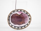 an image of a picture of a pendant with a purple stone inside of it
