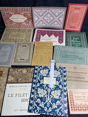 several books are lined up on a table with a blue background