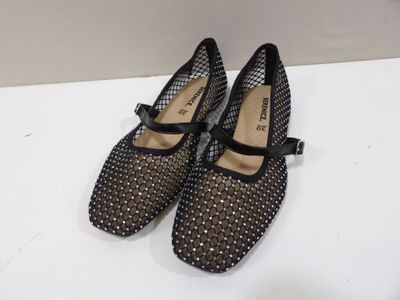 the shoes are black and white with black bows on them