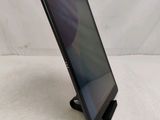 the tablet is sitting on a stand on a white surface