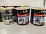 several cans of paint are lined up on a counter