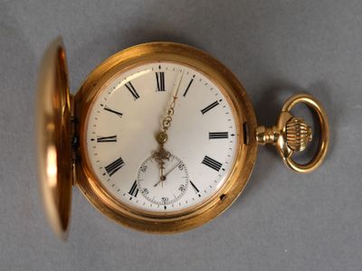 a gold pocket watch with roman numerals on it